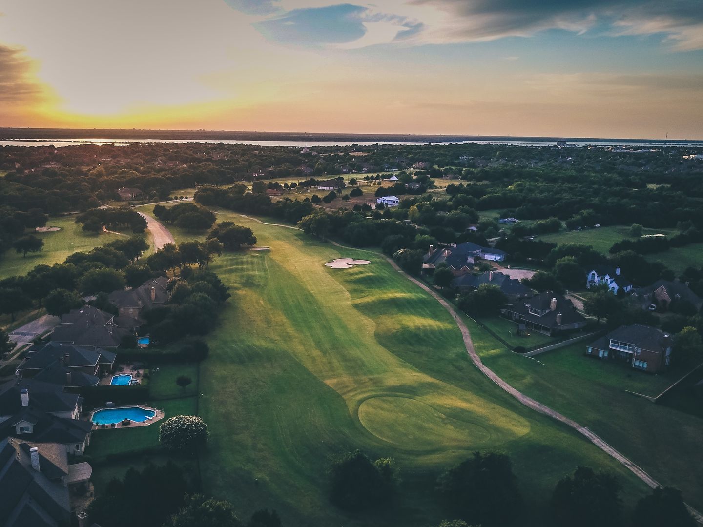 Aerial view of course with fairways and nearby Lake Ray Hubbard in distance