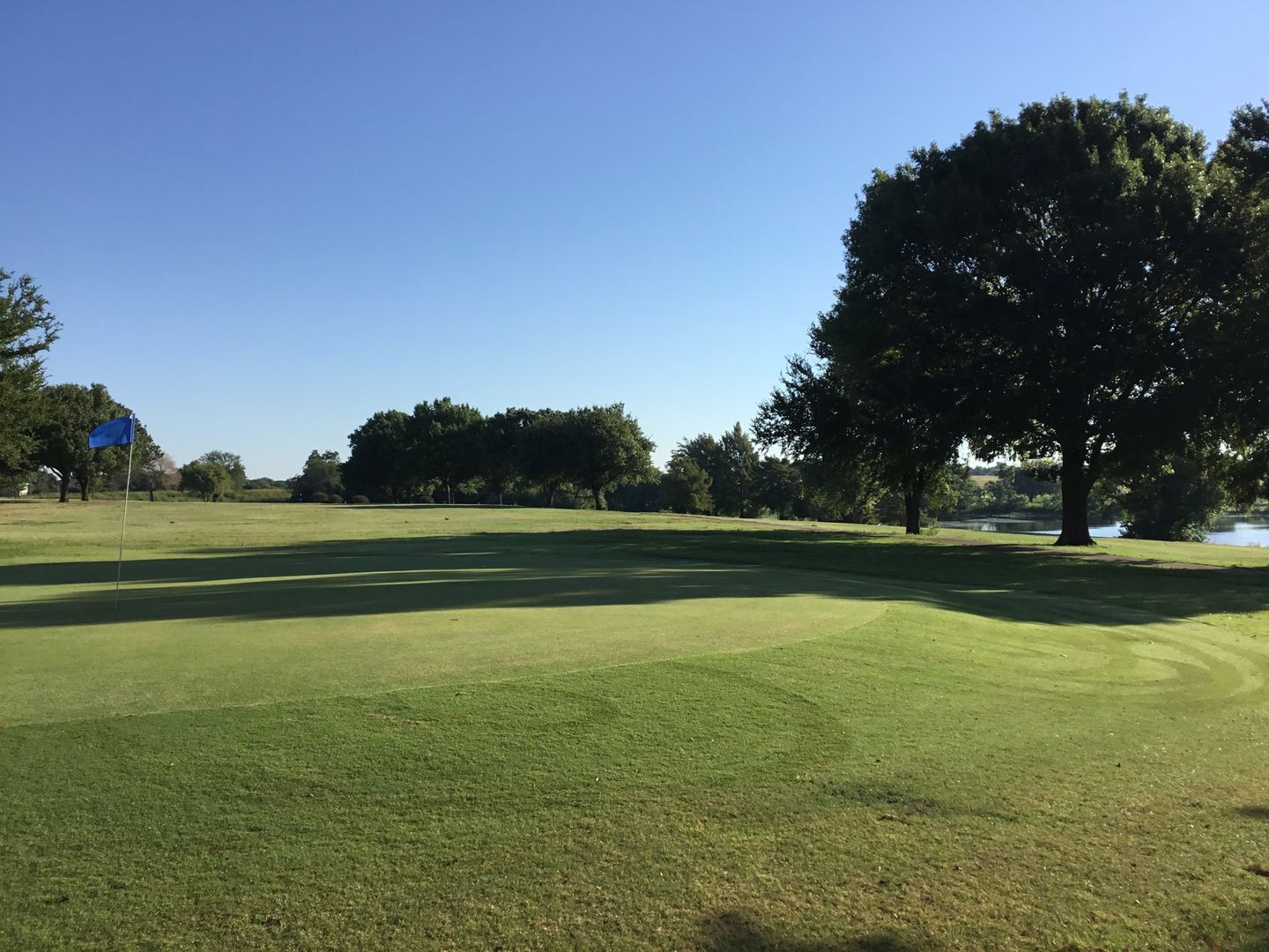 Sunny day view of a green at Waxahachie Golf Club