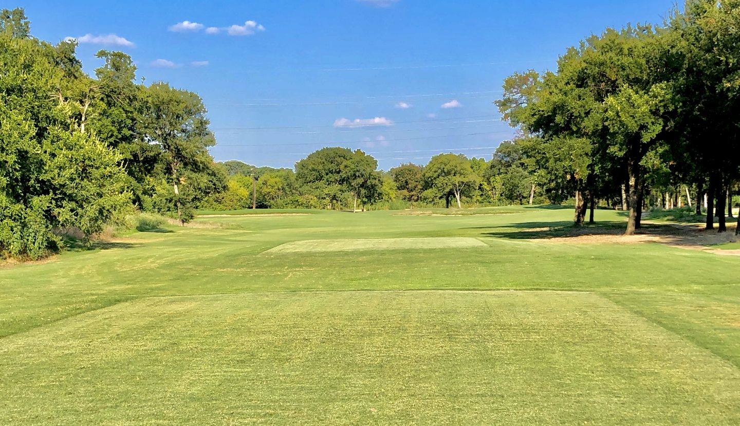 Wide fairway view with Dallas skyline in the distance
